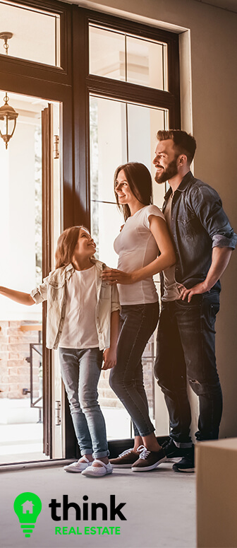 Family standing in a new home in Lynn Haven